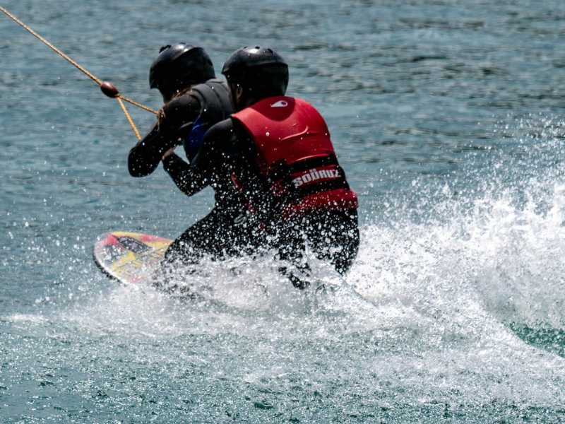 deux personnes sur une planche faisant du téléski nautique près de Lourdes